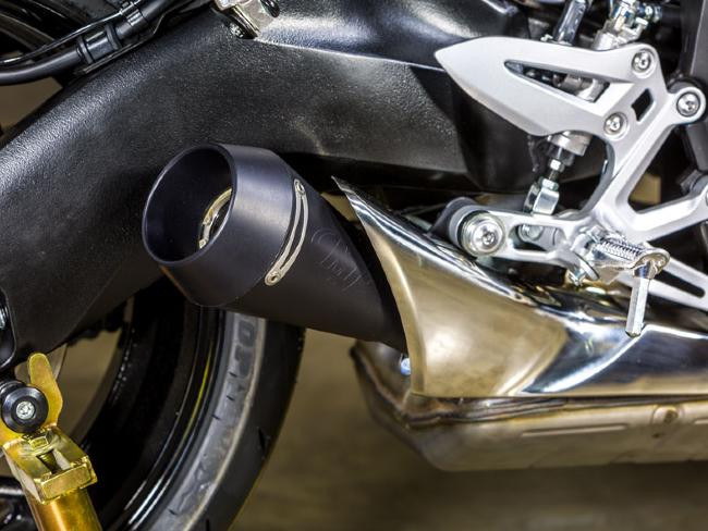 M4 Performance Exhausts M4 GP Black Slip On Exhaust Suzuki GSX-S 1000/1000F (16-20), close-up of black slip-on exhaust installed on motorcycle's rear side showing mounting details and part of the swingarm.