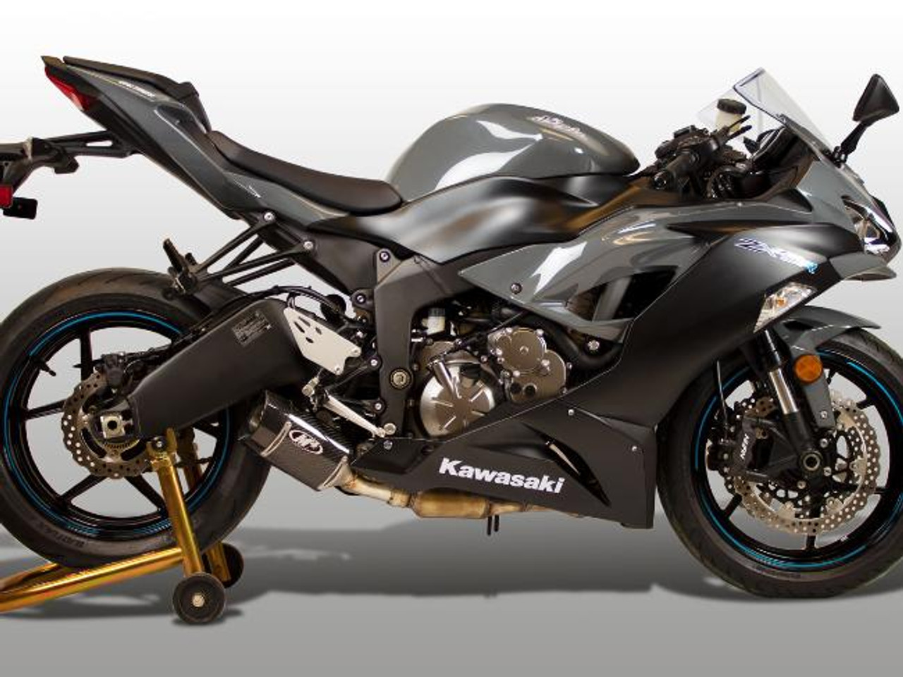 M4 Performance Exhausts M4 Carbon Fiber Street Slayer Slip On Kawasaki ZX-6R (09-25), motorcycle with sleek black and gray design, equipped with high-performance exhaust system and carbon fiber components.