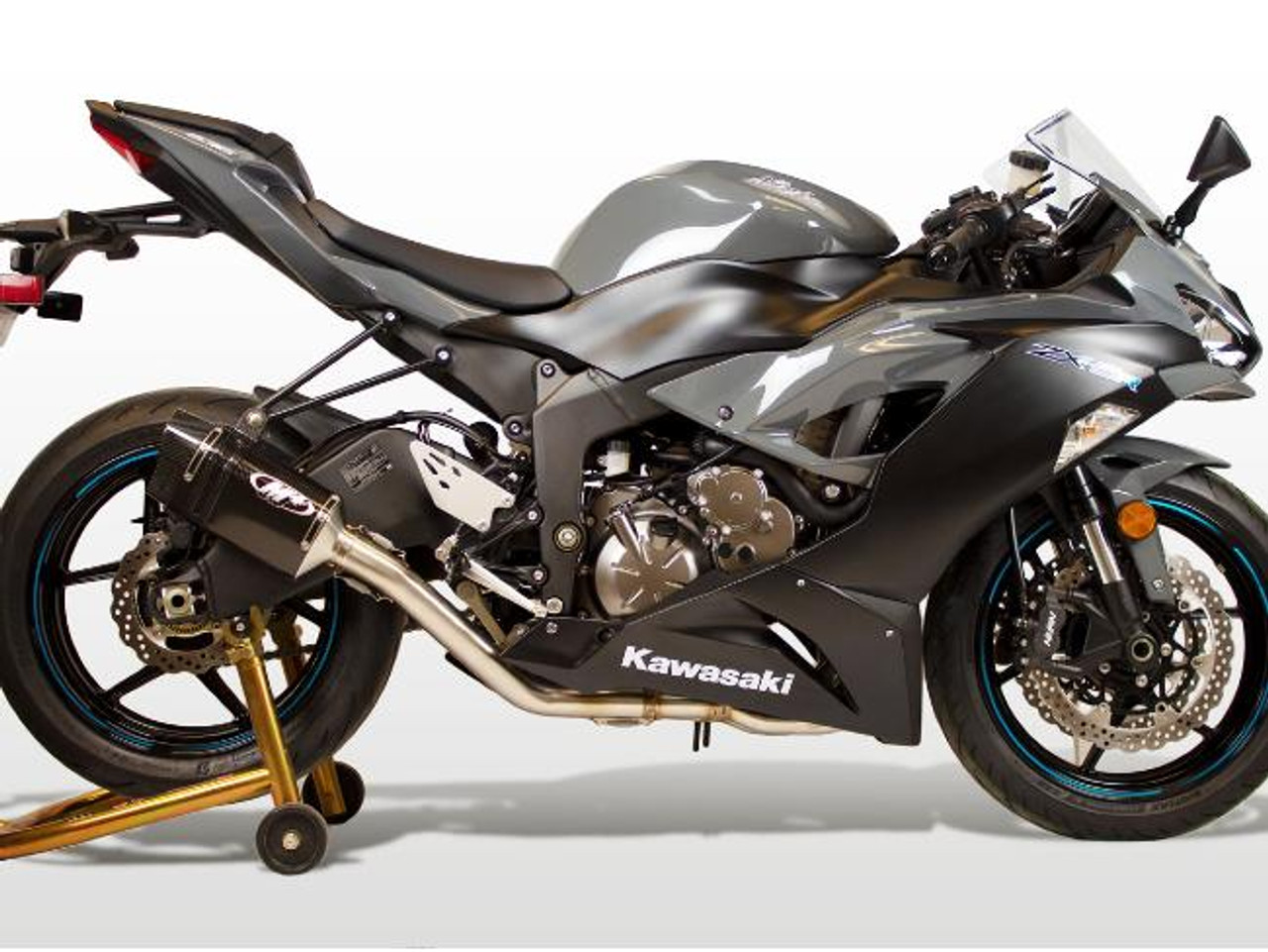 M4 Performance Exhausts M4 Tech1 Carbon Exhaust for Kawasaki ZX-6R (09-25), motorcycle side view showing sleek black and carbon fiber exhaust system installed on a sportbike.