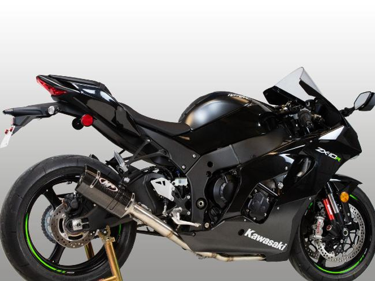 M4 Performance Exhausts M4 Tech1 Carbon Exhaust Kawasaki ZX-10R (16-25), black motorcycle with carbon exhaust, sporty design, and green accents on wheels.