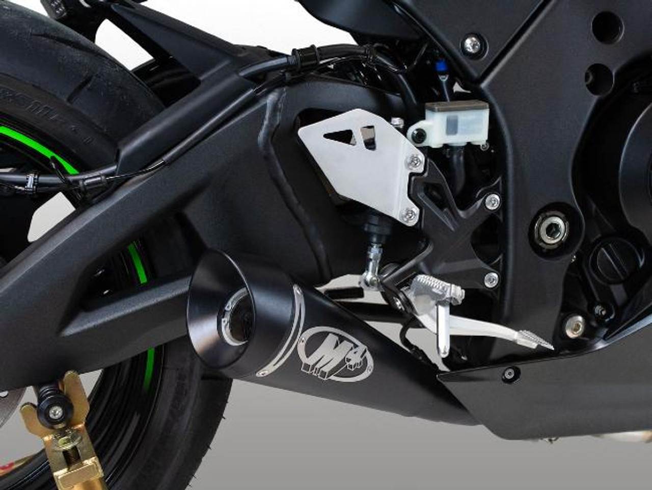 M4 Performance Exhausts M4 GP Black Exhaust for Kawasaki ZX-10R (21-25), close-up of the black motorcycle exhaust system and rear wheel assembly.
