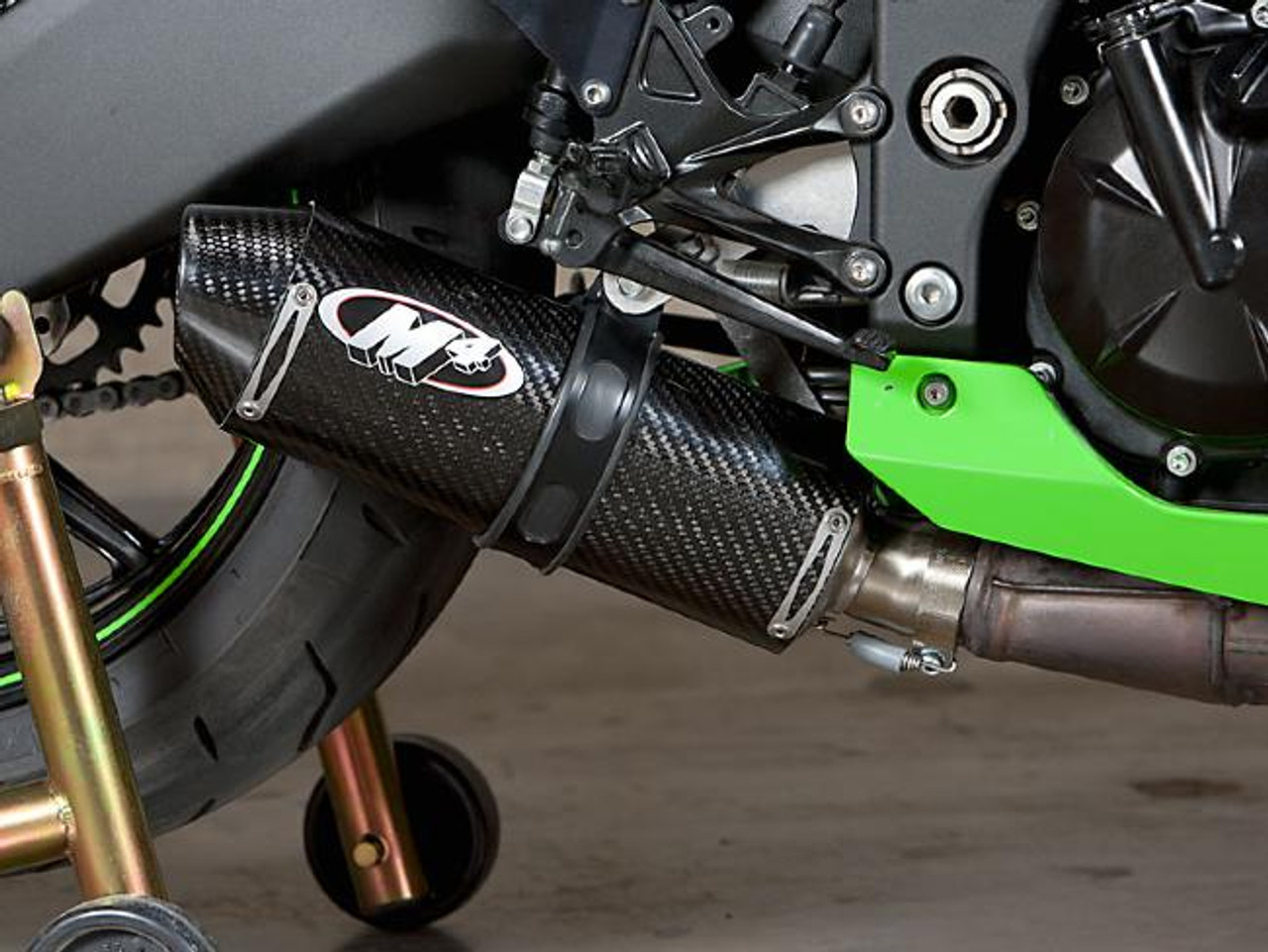 M4 Performance Exhausts M4 Street Slayer Carbon Slip On Exhaust Kawasaki ZX-10R (08-10), close-up view of the black carbon fiber exhaust on a motorcycle with green accents.