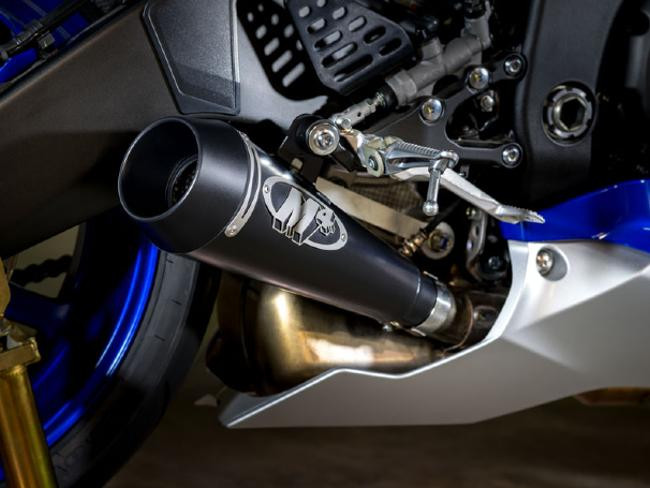 M4 Performance Exhausts M4 GP Black Slip On Exhaust Yamaha YZF-R6 (06-20), close-up of the black slip-on exhaust mounted on a Yamaha YZF-R6 motorcycle, showing the exhaust tip, mounting brackets, and part of the motorcycle's frame.