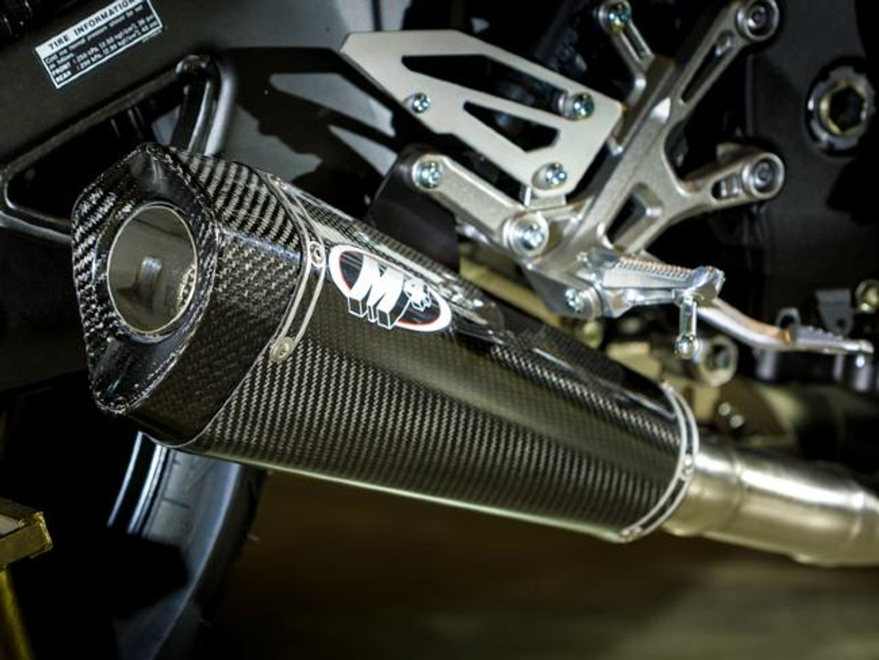M4 Performance Exhausts M4 Carbon Fiber X-Model Slip On Exhaust Yamaha FZ-10/MT-10 (17-24), close-up view of the sleek carbon fiber muffler with M4 logo on a motorcycle.