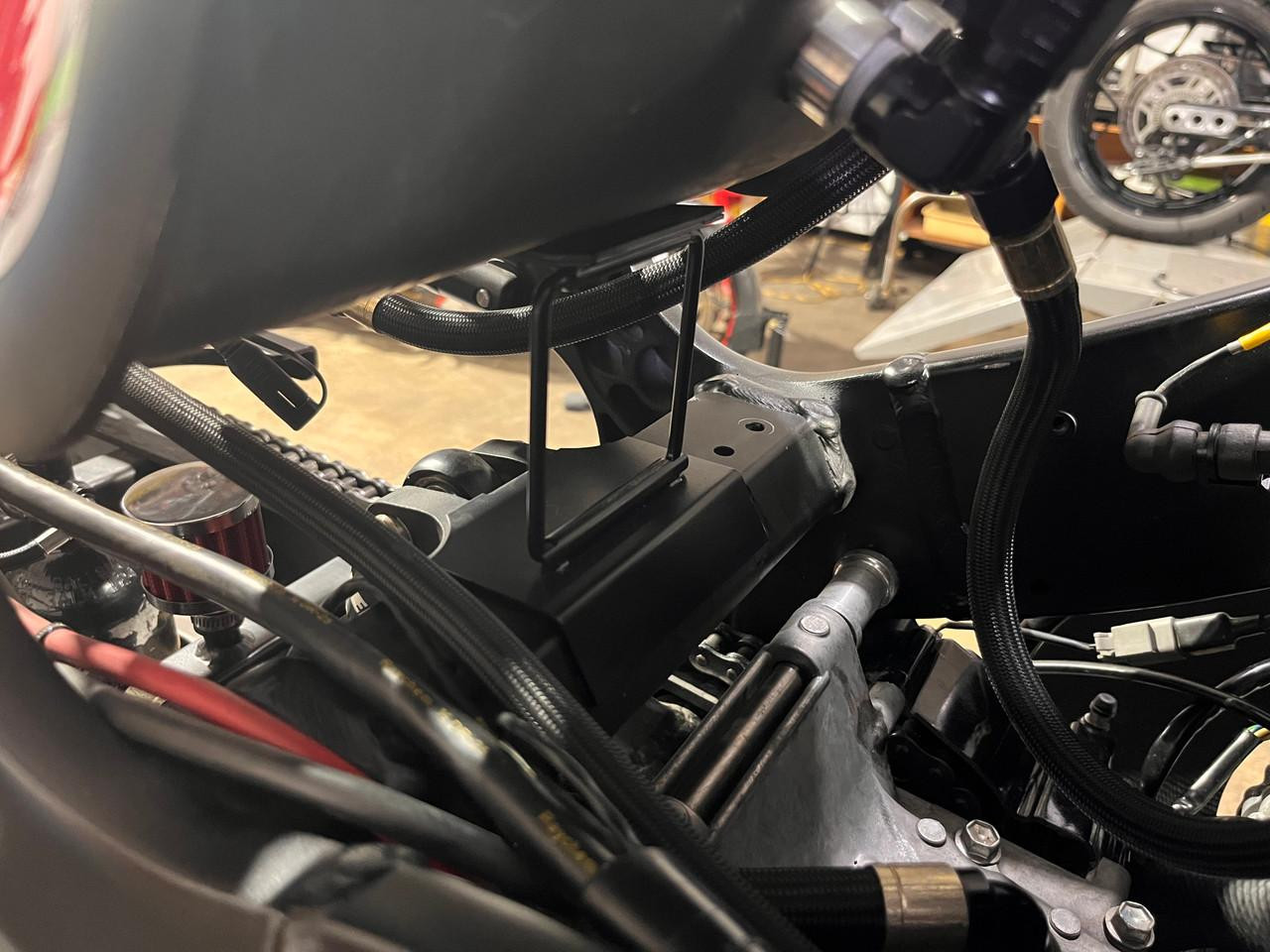 Montgomery Motorsports Tank Stand Suzuki Hayabusa, a black metal stand mounted on a motorcycle's frame for supporting the fuel tank.