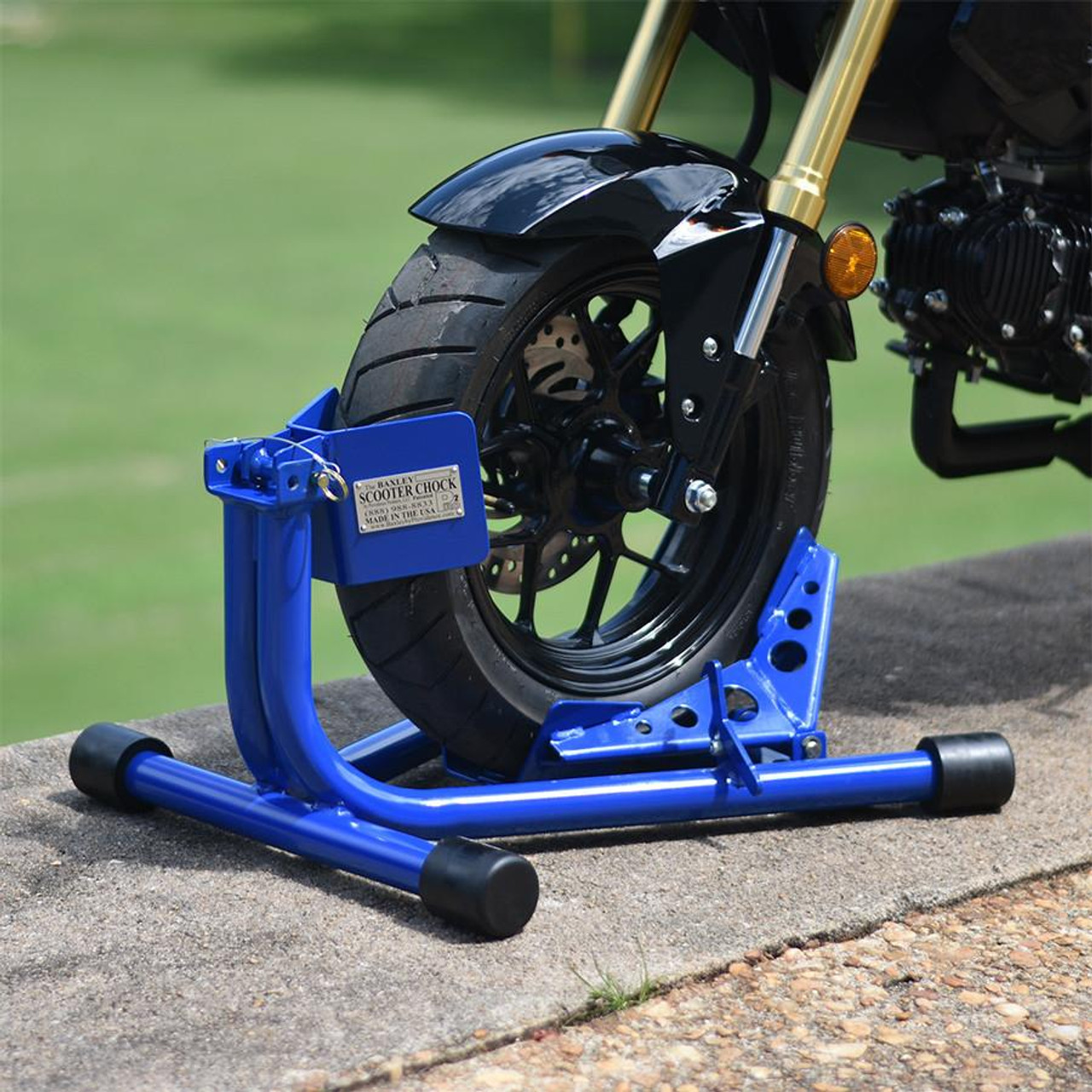 Baxley Small Bore Scooter Chock, blue motorcycle wheel stabilizer for secure parking of small bore scooters.
