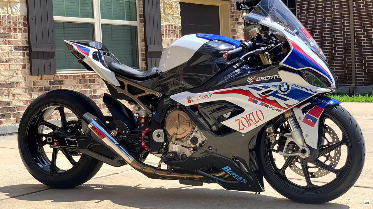 Brocks Performance Brocks Bolt-On Swingarm Extensions BMW S1000RR (20-25), a racing motorcycle with a sporty design, painted in white, blue, red, and black, featuring brand decals and custom modifications.