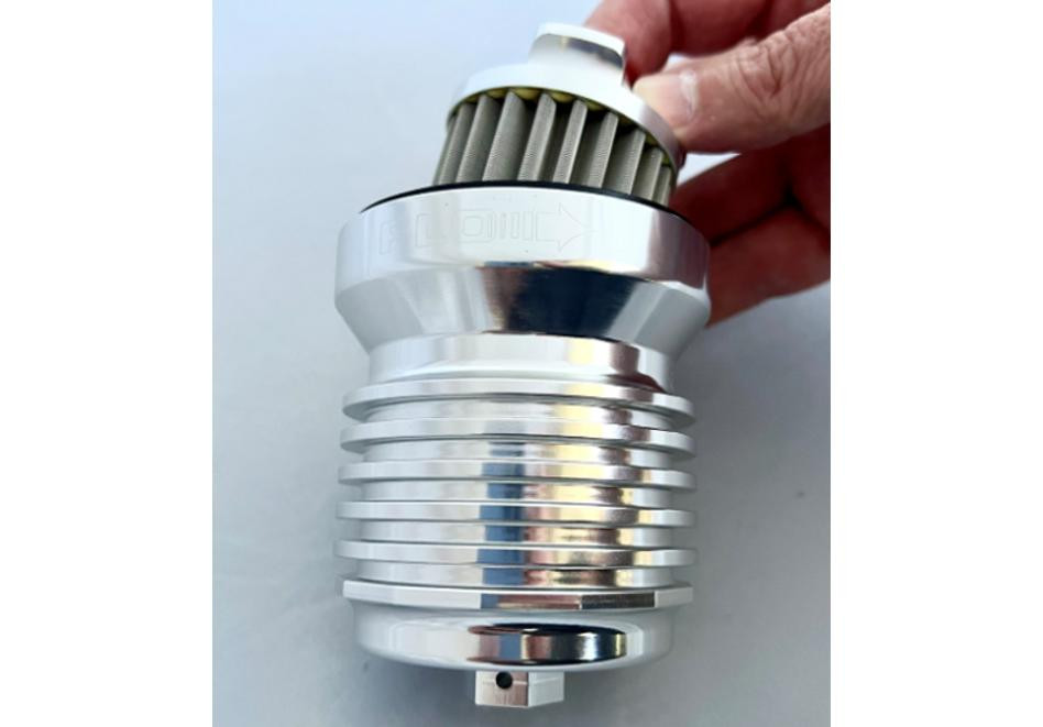 PC Racing Flo Lifetime Reusable Oil Filter Harley-Davidson, close-up view of a metallic, cylindrical oil filter with fins and a filtration element at the top.