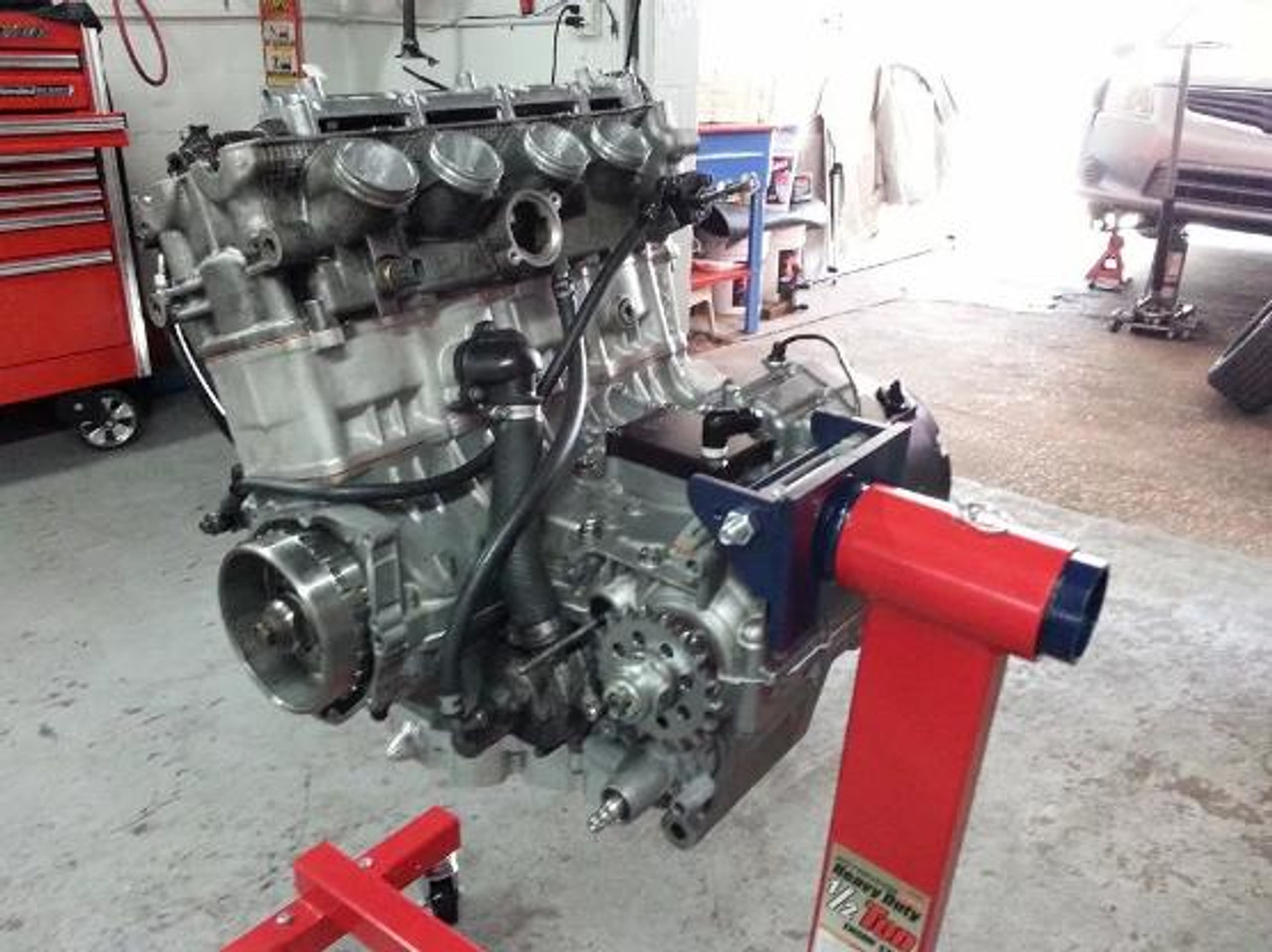 Schnitz Racing Engine Support Bracket Suzuki Hayabusa (99-25), a motorcycle engine support bracket mounted to a Suzuki Hayabusa engine in a workshop setting.