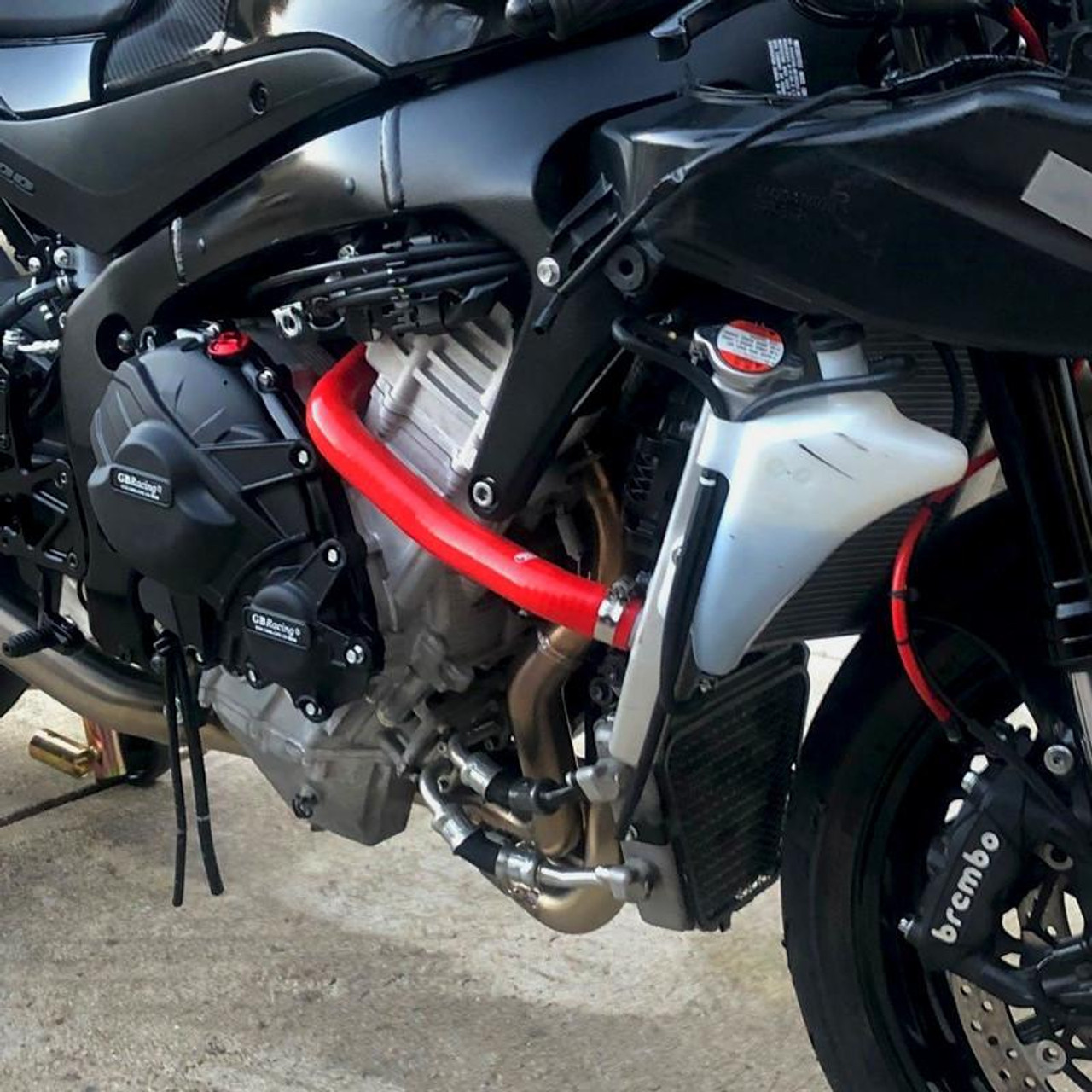 Samco Sport Silicone Radiator Hose Kit Suzuki GSXR1000 (17-25), close-up view of the high-quality silicone radiator hoses installed on a sport motorcycle with red hose fittings. Samco Sport Silicone Radiator Hose Kit Suzuki GSXR1000 (17-25), close-up view of the high-quality silicone radiator hoses installed on a sport motorcycle with red hose fittings.