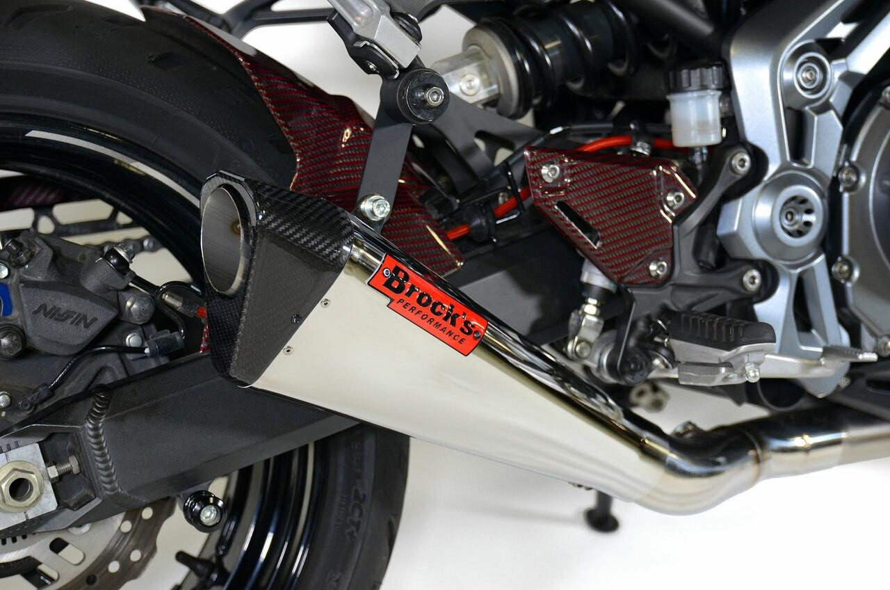 Brocks Performance Brocks Penta-Carbon Full System 15" Muffler Suzuki Hayabusa (99-21), close-up of the high-performance exhaust system mounted on the motorcycle with carbon fiber components and a stainless steel muffler. Brocks Performance Brocks Penta-Carbon Full System 15" Muffler Suzuki Hayabusa (99-21), close-up of the high-performance exhaust system mounted on the motorcycle with carbon fiber components and a stainless steel muffler.