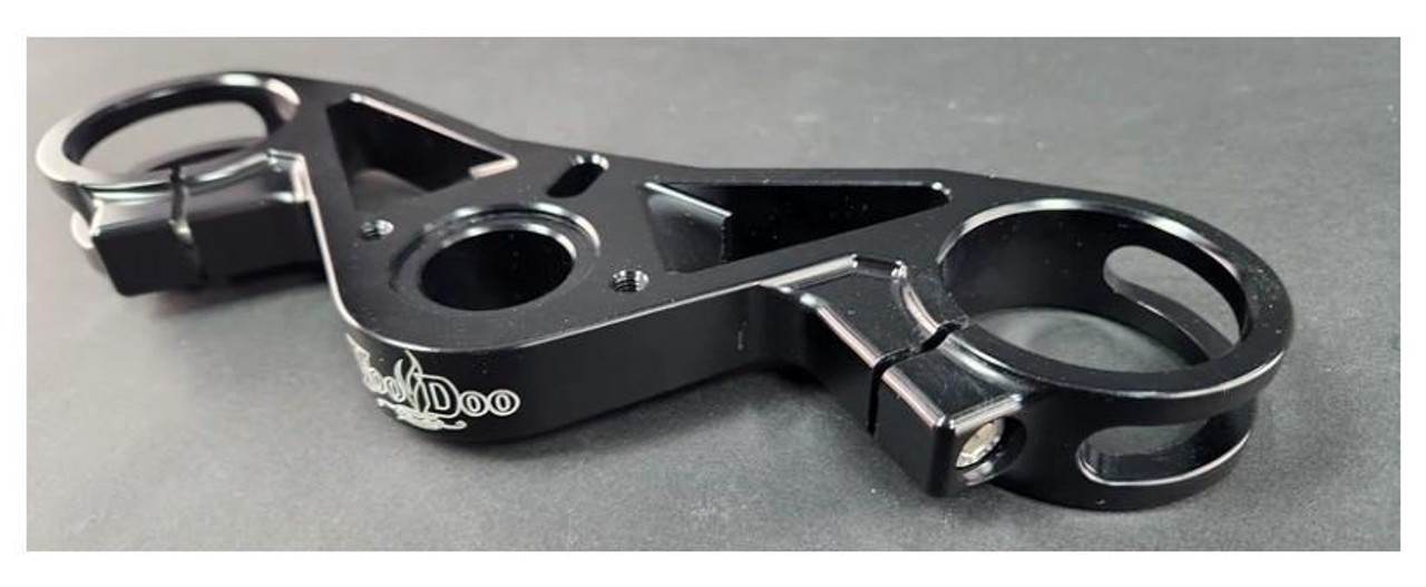 VooDoo Voodoo Top Triple Clamp for Suzuki GSXR1000 (09-25), black metallic motorcycle triple clamp component with mounting holes and circular openings for handlebars and steering