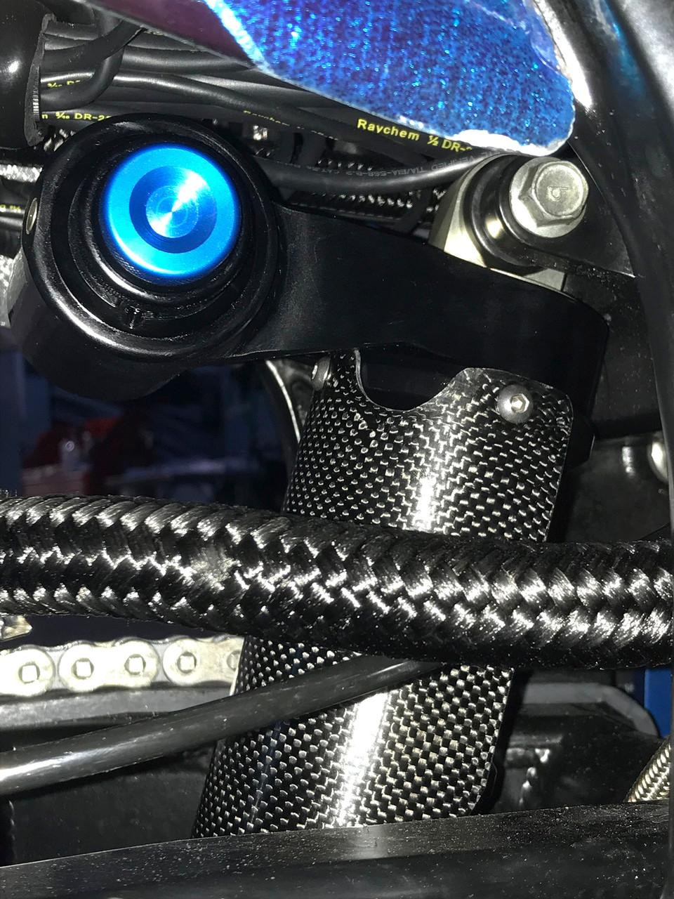 Penske Racing Shocks, Penske Air Drag Shock open box for Suzuki Hayabusa 2008-2021, showcasing the shock absorber with blue LED lights, surrounded by cables and carbon fiber components. Penske Racing Shocks, Penske Air Drag Shock open box for Suzuki Hayabusa 2008-2021, showcasing the shock absorber with blue LED lights, surrounded by cables and carbon fiber components.