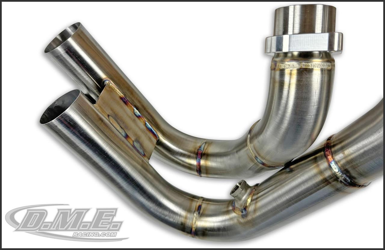 DME Racing Motorcycle Parts DME Zoomie Exhaust System, close-up of polished metal exhaust pipes with welded joints.