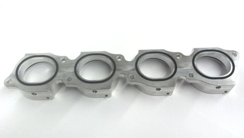 Schnitz Racing Schnitz Nitrous Intake Manifold Suzuki GSXR1000 (05-08), metallic silver motorcycle intake manifold with four circular openings and gasket seals. Schnitz Racing Schnitz Nitrous Intake Manifold Suzuki GSXR1000 (05-08), metallic silver motorcycle intake manifold with four circular openings and gasket seals.
