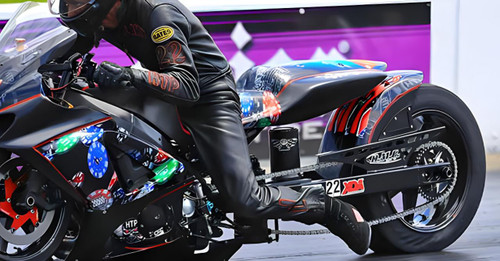 DME Aluminum Swingarm Suzuki GSXR1000 (07-08), motorcycle swingarm on a racing bike with vibrant graphics and a blurred background. Loading Image