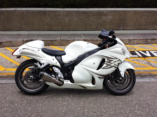 Brocks Performance Brocks CT Megaphone Exhaust Suzuki GSX1300R Hayabusa (08-26), a white sport motorcycle with black accents and a custom exhaust system, parked on a street.
