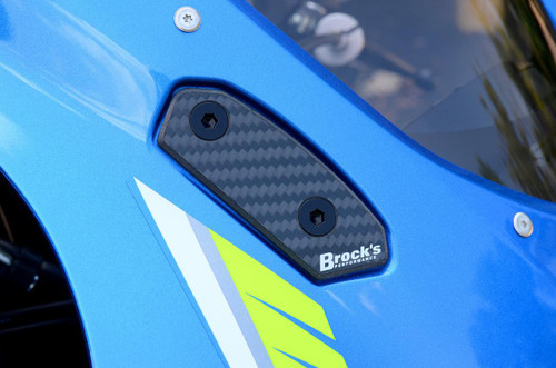 Brocks Performance Brocks Carbon Fiber Mirror Block Off Plates Suzuki GSXR1000 (17-25), close-up view of black carbon fiber mirror block-off plates installed on a blue motorcycle. Brocks Performance Brocks Carbon Fiber Mirror Block Off Plates Suzuki GSXR1000 (17-25), close-up view of black carbon fiber mirror block-off plates installed on a blue motorcycle.