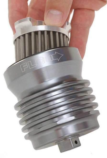 PC Racing Flo Lifetime Reusable Oil Filter Kawasaki ZX6R/RR (95-20), metallic oil filter with grooves and arrow indicating flow direction, held by a person's fingers.