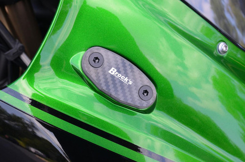 Brocks Performance Brocks Carbon Fiber Mirror Block Off Plates for Kawasaki Ninja H2 SX / SE (18-19), close-up of the black carbon fiber mirror block off plate with white logo on a green motorcycle.