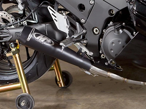 M4 Performance Exhausts M4 GP Black Exhaust Kawasaki ZX-14R (12-25), close-up of the black motorcycle exhaust with a skull logo and gold-colored rear stand.