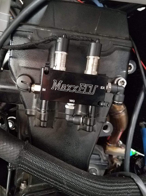 MaxxECU Boost Control Dual Solenoid Kit, black metal dual solenoid valve installed on an engine for boost pressure regulation. Loading Image