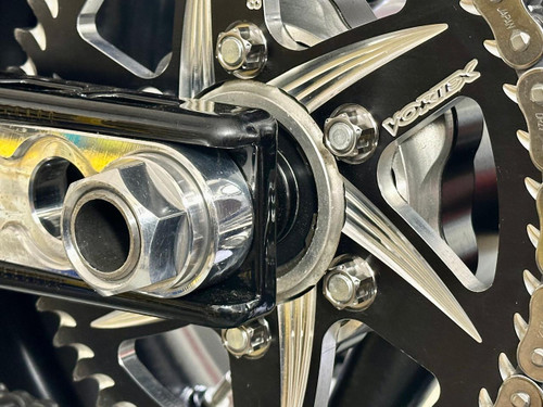 Ironless Innovations Titanium Sprocket Nut Kit, 10mm x 1.25, on bicycle sprocket with bolts and chainring in close-up view.