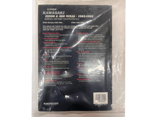 Service Manual for Kawasaki ZX500 and 600 Ninja (85-92), inspecting the printed cover of the technical guide with detailed information on maintenance and repair procedures.