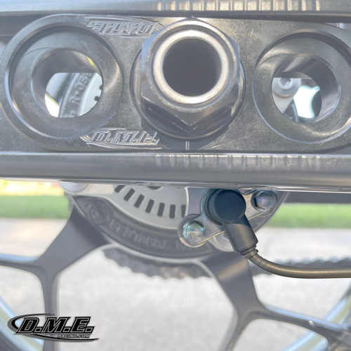 DME Rear Brake Eliminator Spacer With Sensor Mount Kawasaki ZX-14R (06-25), close-up image showing the spacer, sensor mount, and brake components on a motorcycle.