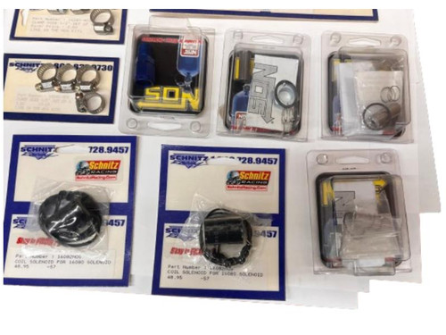 Schnitz Racing Miscellaneous NOS Supplies, assortment of NOS nitrous oxide system parts in their packaging and display.