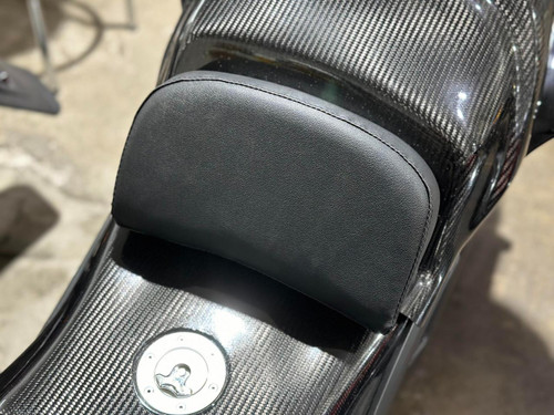 Schnitz Racing Schnitz Seat Backing Pad Universal, black leather pad attached to motorcycle seat with carbon fiber finish.