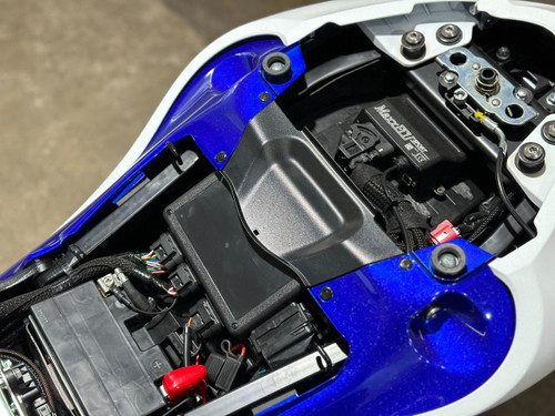 Schnitz Racing MaxxECU Sport Plug and Play Kit Suzuki Hayabusa (22-25), close-up view of the electronic control unit installed in the motorcycle's engine compartment with various wires and components visible.