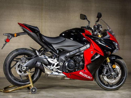 M4 Performance Exhausts M4 GP Black Slip On Exhaust Suzuki GSX-S 1000/1000F (16-19), motorcycle with aftermarket exhaust system installed in a garage setting.