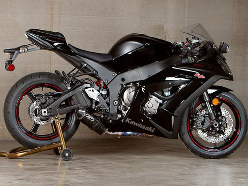 M4 Performance Exhausts M4 Street Slayer Carbon Slip On Exhaust for Kawasaki ZX-10 (11-15), black motorcycle with carbon exhaust, shown on a stand in an indoor setting.