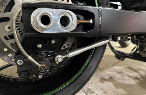 DME Brake Stop for DME Racing Swingarm Kawasaki ZX-14R (06-25), close-up of motorcycle rear wheel with brake stop component, hardware, and braided brake line.