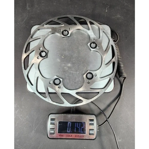 VooDoo Motorcycle Components Lightweight Rear Brake Rotor Yamaha YZF-R1 (04-25) YZF-R6 (03-26), metal motorcycle brake disc with cut-out design, placed on digital scale showing 1.42 pounds.