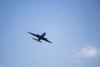 airplane crosses a clear blue sky