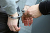 man arrested in handcuffs by police