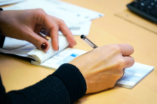 woman writing out check