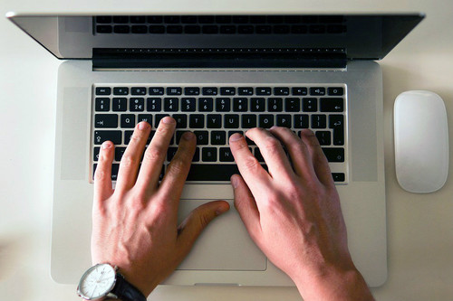 person types on laptop person types on laptop