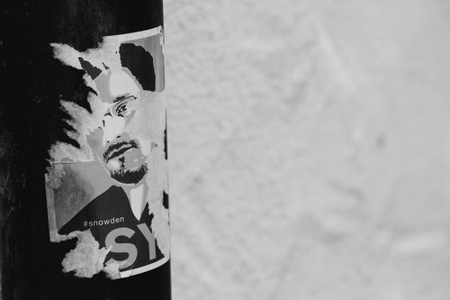 poster of Snowden partially removed on telephone post 