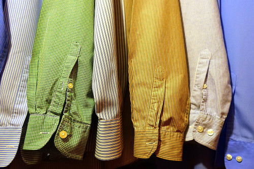 a close of the sleeves of colorful button-down shirts