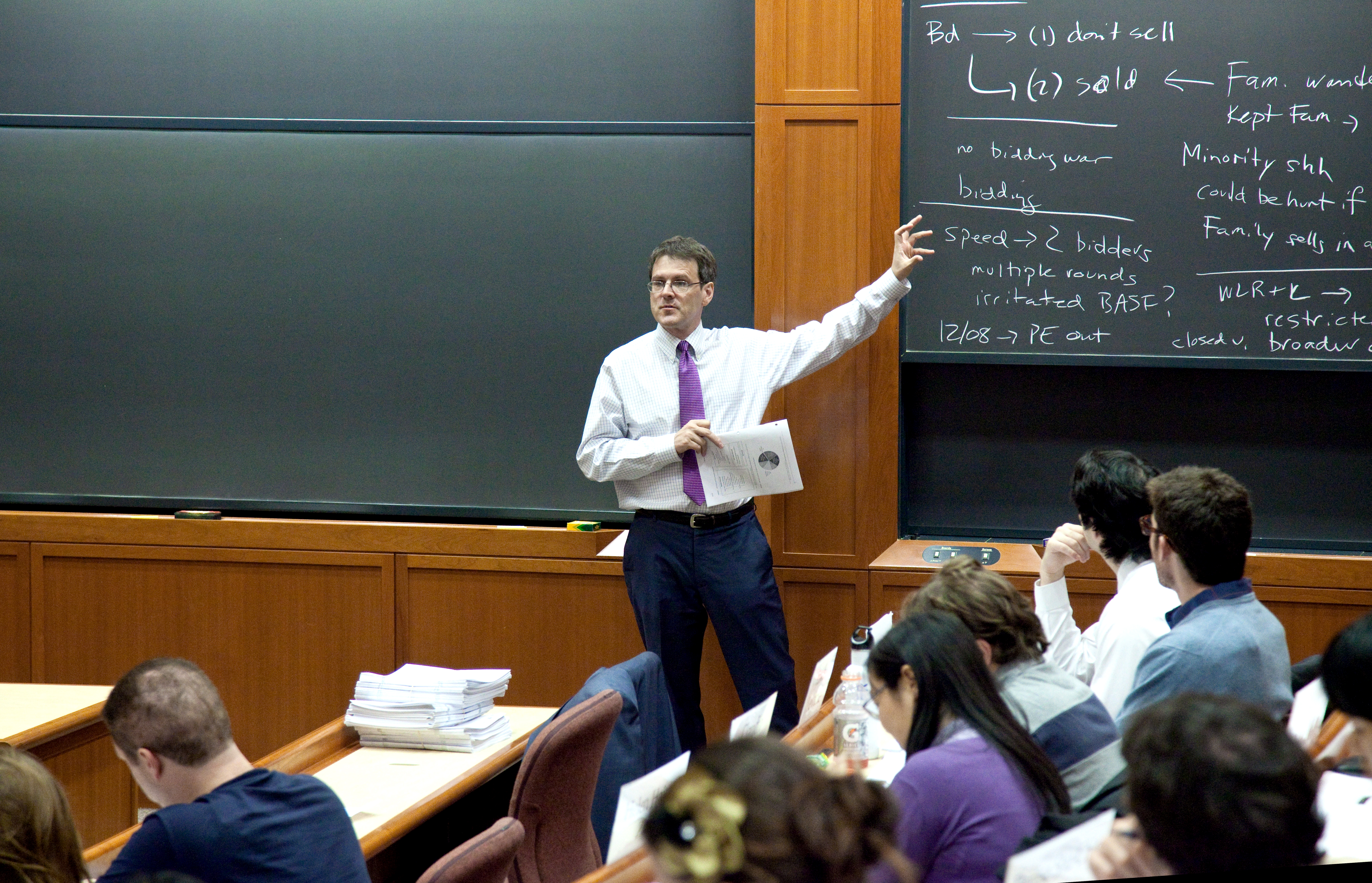 Professor John Coates lecturing to his class at the blackboard