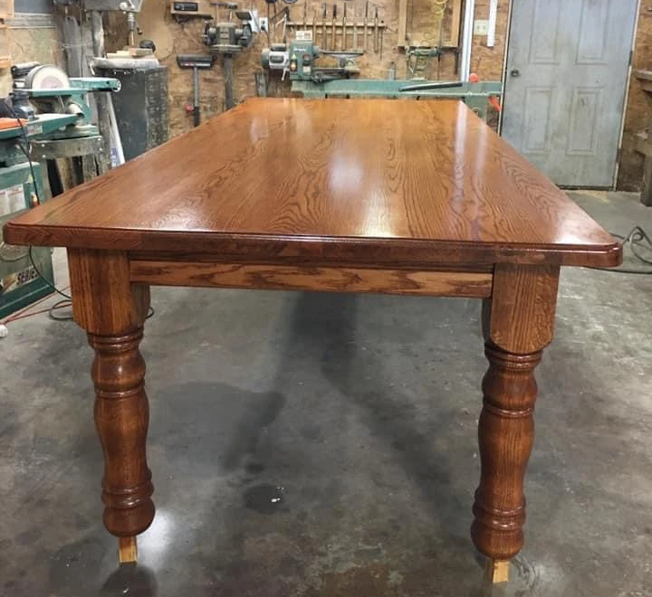 Oak dining table built with Highland Manor wood legs