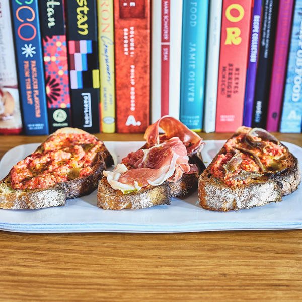 Tomato toast with Fresh Parsley Oil and a variety of things on top