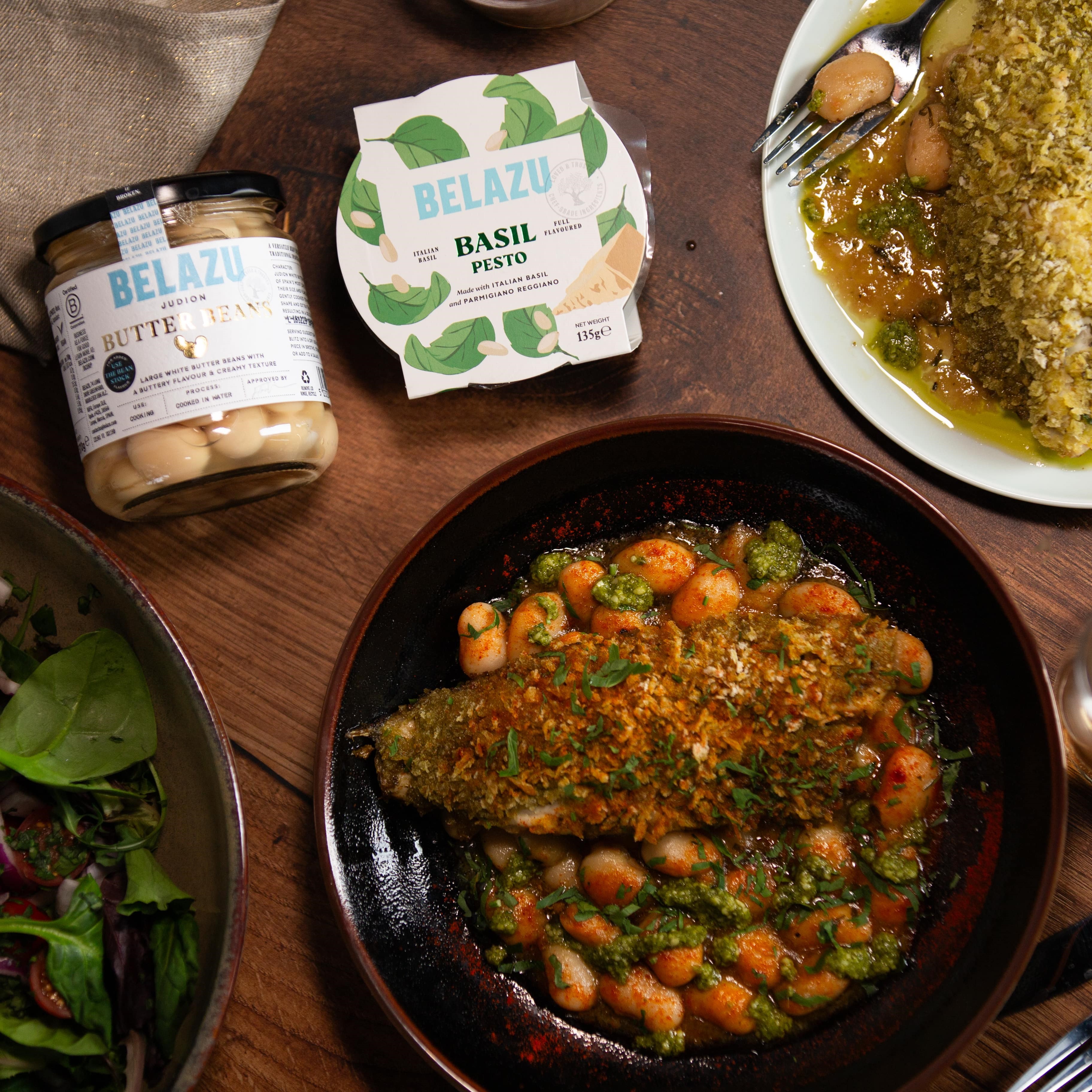 Pesto Crusted Seabass with Roasted Garlic Judion Butter beans