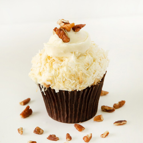 Luscious Italian cream cake and cream cheese icing topped with toasted coconut