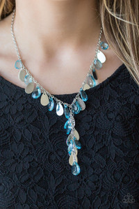 Flat silver teardrops and blue crystal-like teardrops swing from the bottom of a shimmery silver chain below the collar. A matching tassel swings from the center, creating a whimsical extended pendant. Features an adjustable clasp closure.
Sold as one individual necklace. Includes one pair of matching earrings. Flat silver teardrops and blue crystal-like teardrops swing from the bottom of a shimmery silver chain below the collar. A matching tassel swings from the center, creating a whimsical extended pendant. Features an adjustable clasp closure.
Sold as one individual necklace. Includes one pair of matching earrings.