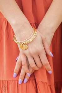 Five classic gold bangles stack up the wrist. A glistening collection of dainty gold beads and textured gold discs slide along two of bangles, creating shimmery charms.
Sold as one individual bracelet. Five classic gold bangles stack up the wrist. A glistening collection of dainty gold beads and textured gold discs slide along two of bangles, creating shimmery charms.
Sold as one individual bracelet.