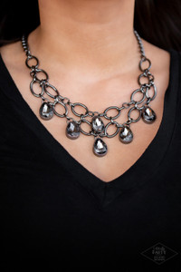Joined by dainty gunmetal links, two rows of dramatic gunmetal chain layer below the collar in a fierce fashion. Smoky teardrops drip from the glistening layers, adding a timeless shimmer to the show-stopping piece. Features an adjustable clasp closure.

Sold as one individual necklace. Includes one pair of matching earrings.